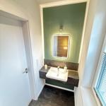 Bathroom with sink, mirror, and window