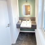 Bathroom with sink, mirror, and window