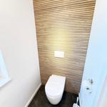 Toilet with wooden wall and toilet paper holder