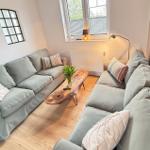 Living room with gray sofa, wooden table, and window
