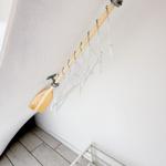 Clothes hanger system with wooden paddle mounted on wall