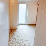 Hallway with pebble floor and window to outside door.