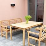 Terrace with wooden table, benches, and flowers