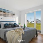 Schlafzimmer mit Bett, Fenster und Wandbild