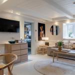 Wohnzimmer mit Sofa, Fernseher und Küchenbereich
