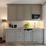 Kitchen with light cabinets, sink, and window view.