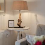 Table with lamp, WLAN sign, and armchair in room