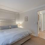 Bedroom with bed, nightstands, and view into the bathroom.