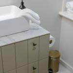 Sink with towel on marble top and beige cabinet
