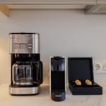 Kitchen area with coffee maker and Nespresso machine.