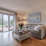 Living room with sofa, table, and view of garden