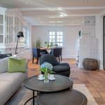 Living and dining area with sofa, table, and fireplace.