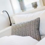 Bed headboard with pillows and bedside lamp