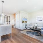 Living and dining area with sofa, table, and TV.