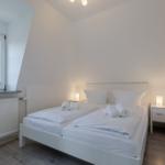 Schlafzimmer mit Doppelbett, Fenster und Nachttischen