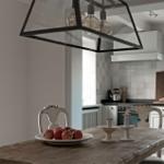 Dining room with wooden table, chairs, and kitchen area in the background.