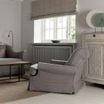 A living room with a gray sofa, armchair, and a white cabinet.