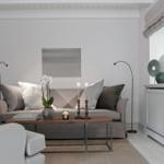 Living room with sofa, coffee table, and white cabinets.