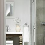 Bathroom with shower, sink, and mirror