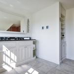 Bathroom with double sink, mirror, and freestanding bathtub.