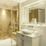 Bathroom with shower, sink, and mirror
