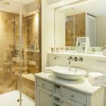 Bathroom with shower, sink, and mirror