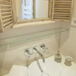 Bathroom with sink, mirror, and towel
