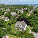 Village with thatched houses and view of the sea