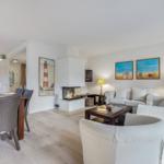 Living and dining area with fireplace, sofa, and dining table.