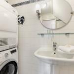 Bathroom with washing machine, dryer, and sink