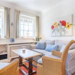 Living room with sofa, chairs, and painting on the wall.