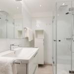 Bathroom with shower, sink, and mirror