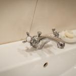 Sink with chrome faucet and soap dish