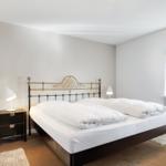 Bedroom with double bed, nightstand, and window.