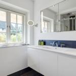 Bathroom with window, mirror, and sink