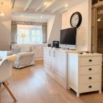 Living and dining area with sauna and TV.
