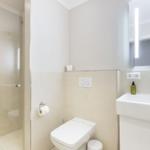 Bathroom with shower, toilet, and sink.