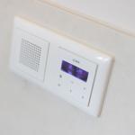 Wall-mounted audio control with display and speaker