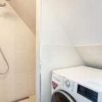 Shower and washing machine under the sloped ceiling
