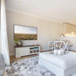 Living area with TV, dining table, and kitchen area.