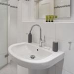 Sink with mirror and shower in bathroom