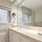 Bathroom with sink, mirror, and window