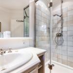 Bathroom with shower, sink, and mirror