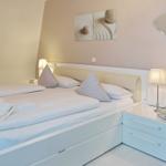 Bedroom with bed, nightstand, and wall art.