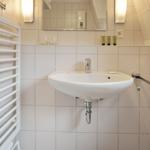 Bathroom with sink, mirror, and heater