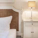 Bed headboard with rattan, nightstand and lamp