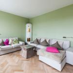 Living room with two sofas, table, and wooden floor.