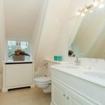 Bathroom with double sink, mirror, and window