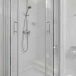 Shower cabin with glass door and showerhead