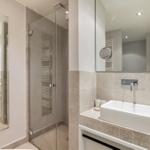 Badezimmer mit Dusche, Waschbecken und Spiegel